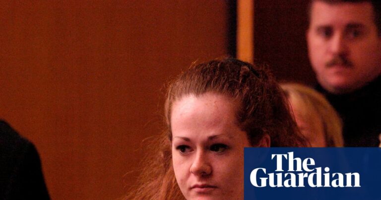 Death row inmate Christa Pike, in red jumpsuit, walks ahead of an officer in court